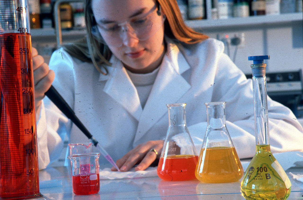 Woman using chemistry lab equipment