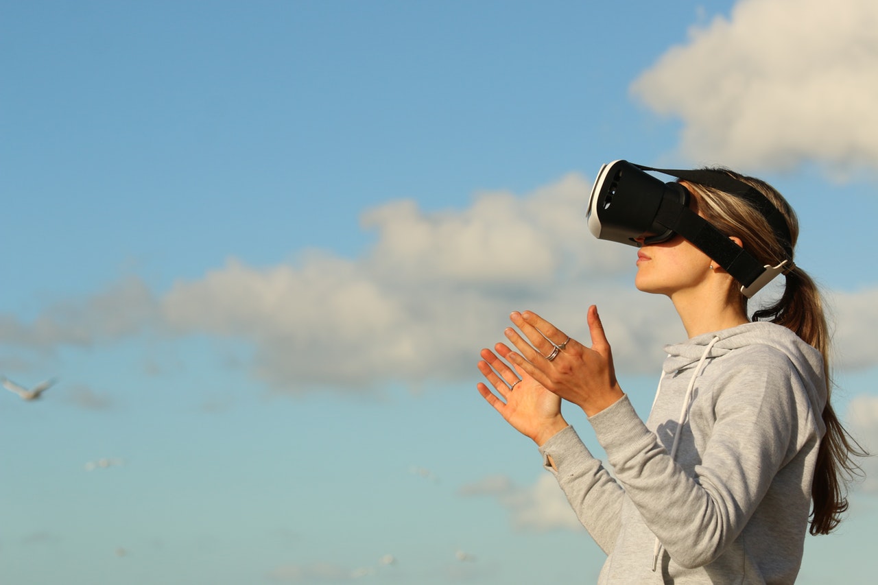 Woman wearing VR goggles outside